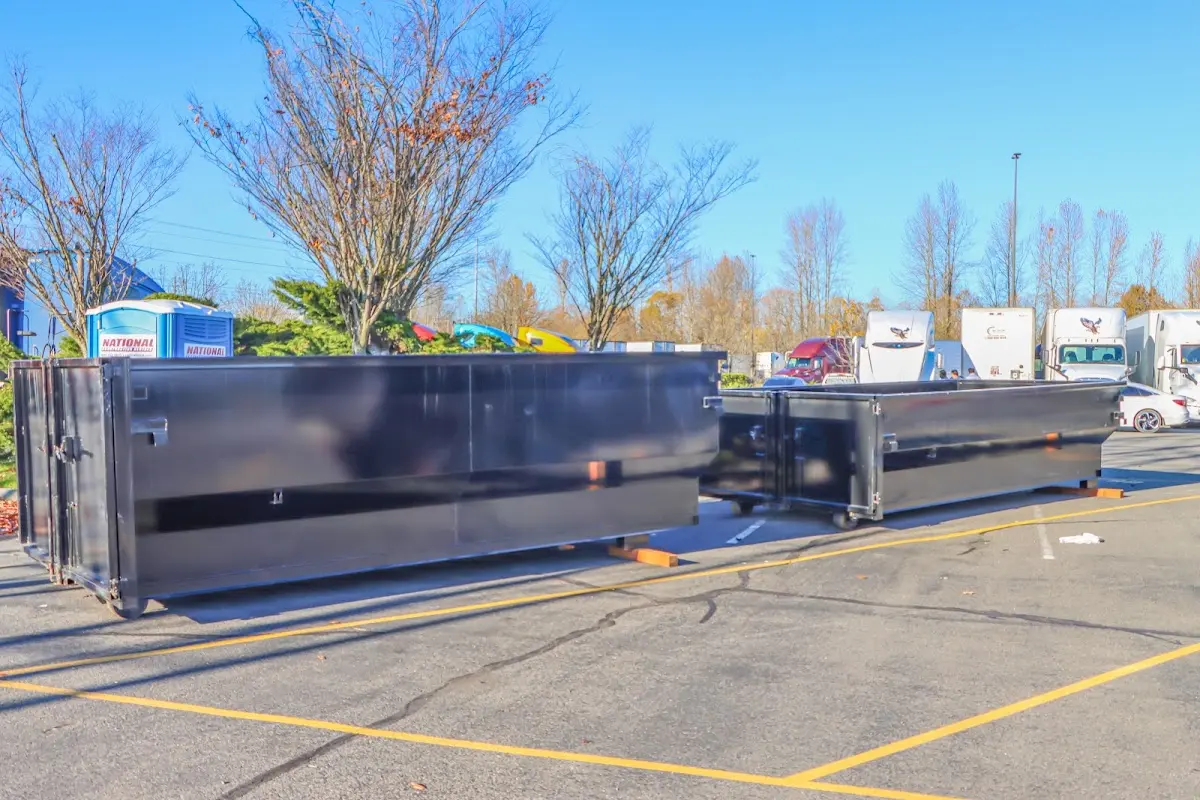 Professional dumpster rental service with roll-off container on residential driveway in Lake Tapps